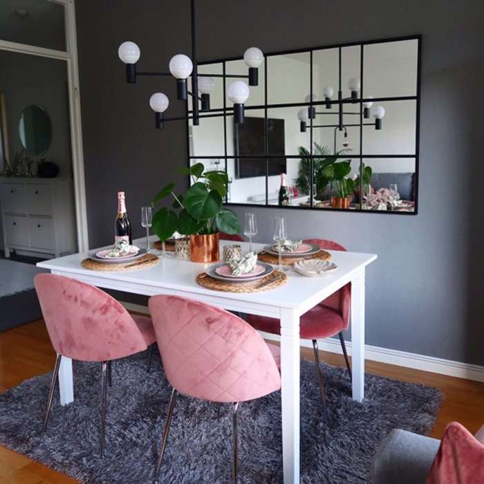 Dining room with large black mirrored panel