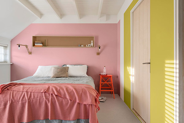 Beautiful and cheerful double bedroom painted pink and yellow