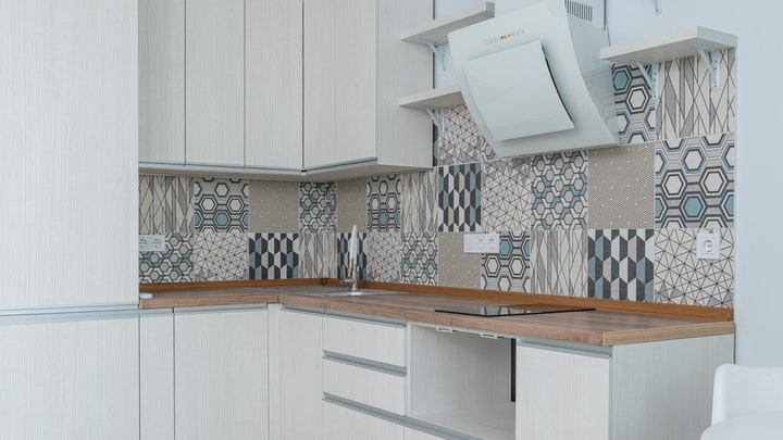 white-furniture-and-geometric-tiled-kitchen