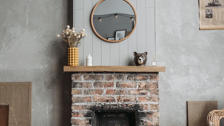 round mirror over the fireplace