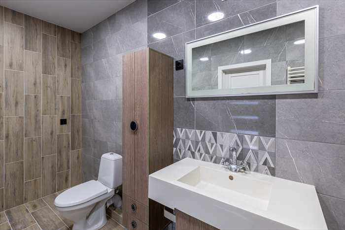 grey bathroom with wooden shower