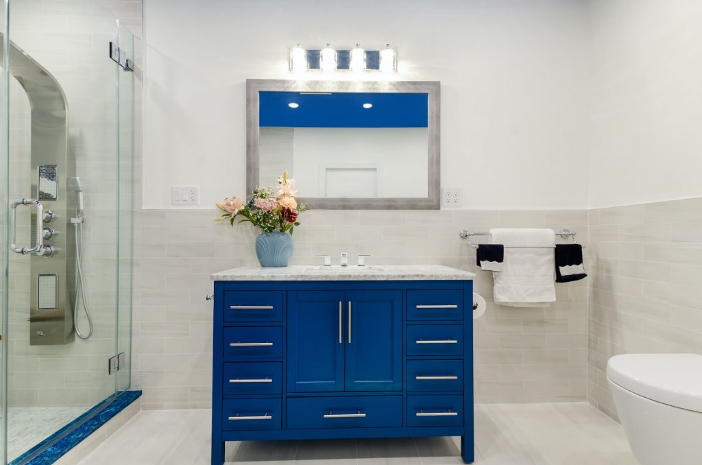 white bathroom with blue furniture