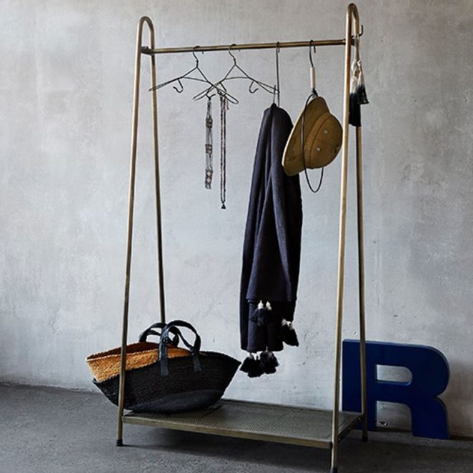 The brass shelf has two different areas to create a mini dressing room: a shelf and a low shelf