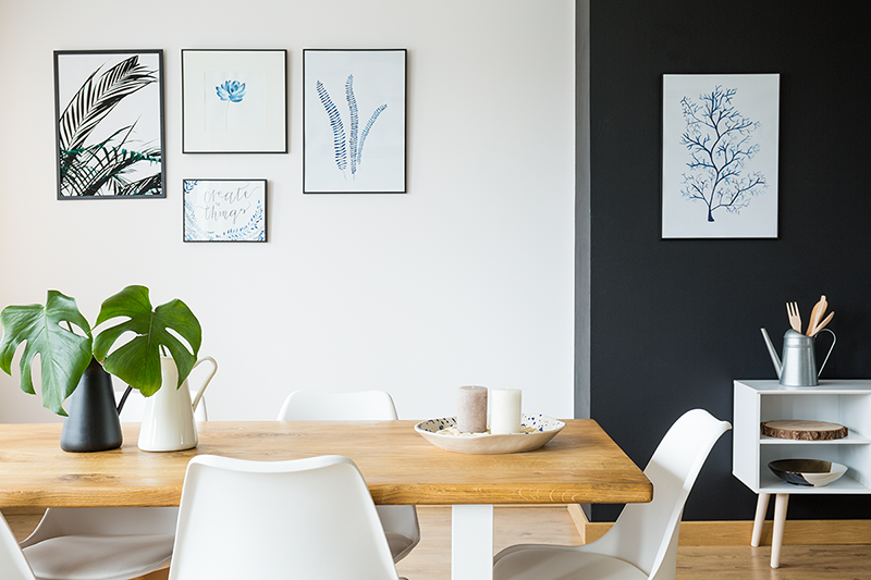 black and white dining room wall using frames and pictures