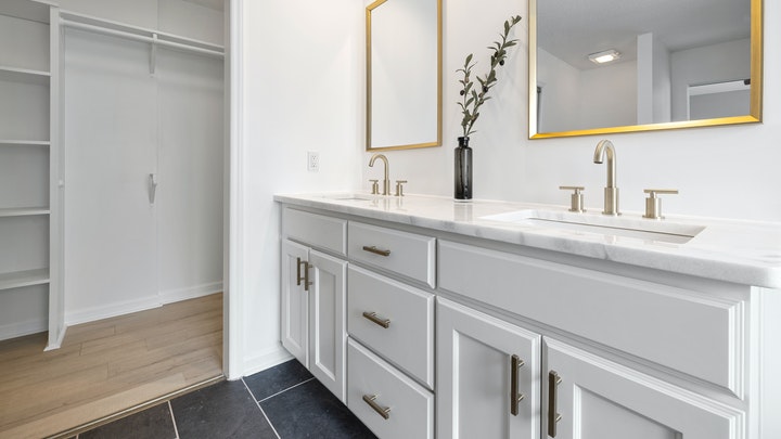 bathroom with two gold mirrors