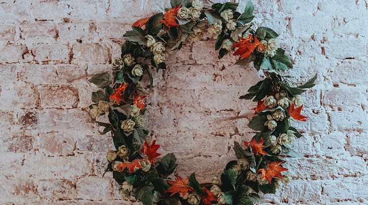 green Christmas wreath on brick wall