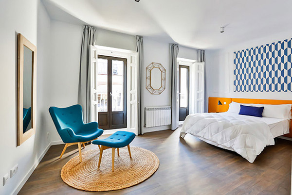 Cheerful and pleasant double bedroom in dark blue and orange