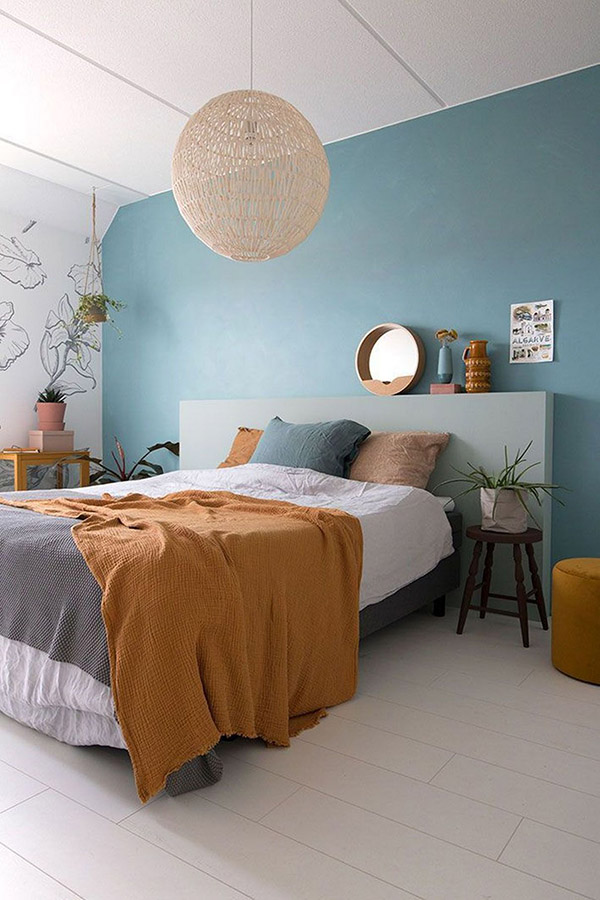 Cheerful and beautiful double bedroom in blue and mustard color