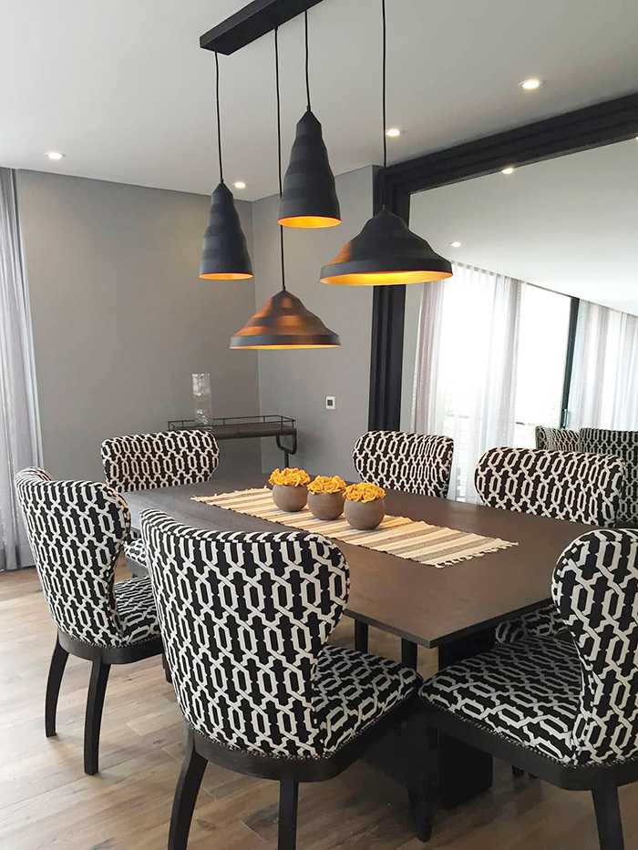 A dining room with a large mirror leaning against the wall