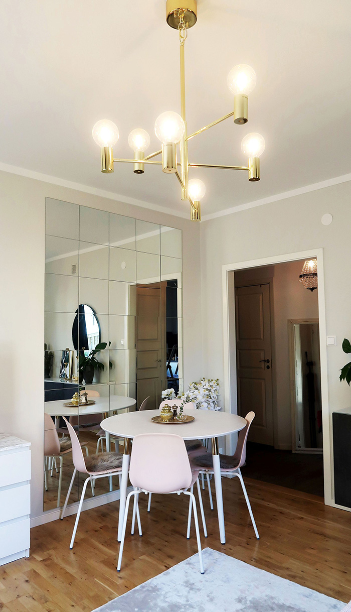 Dining room decorated with a beveled mirror wall