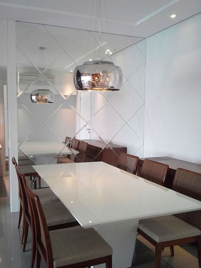 Dining room decorated with a beveled mirror wall