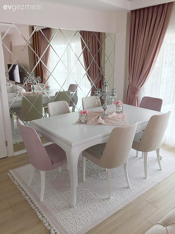 Dining room decorated with a beveled mirror wall