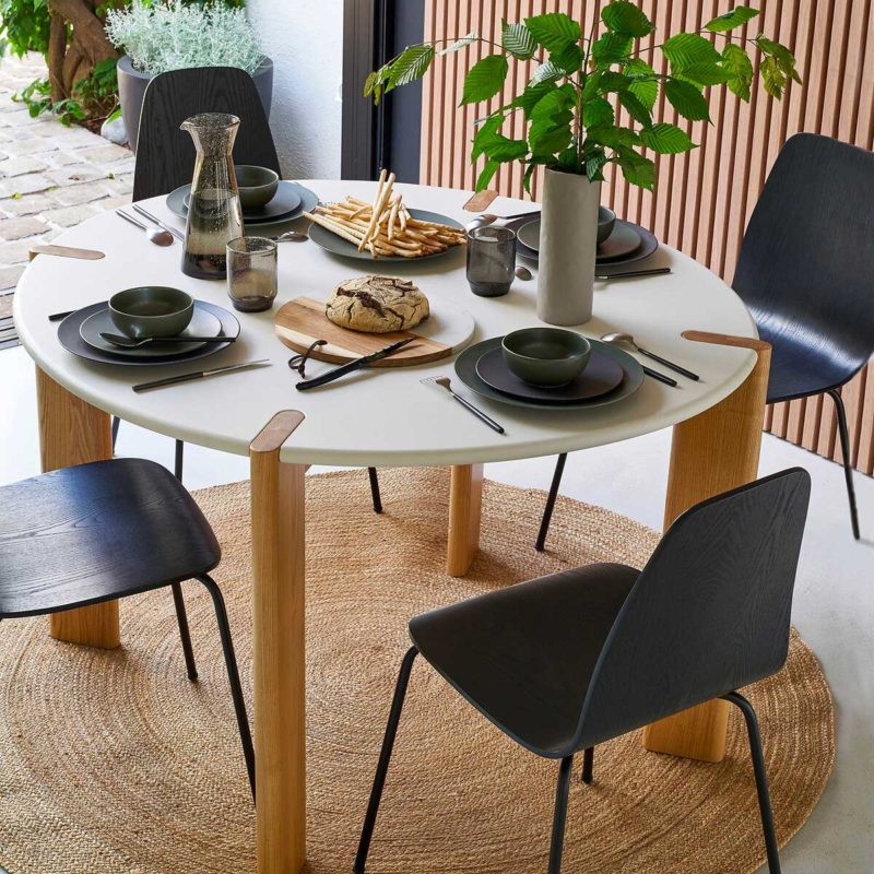 Round table with white top and wooden legs