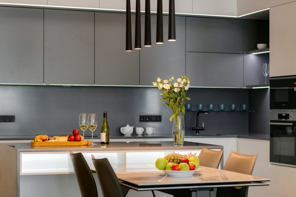 How Kitchen Remodeling Can Increase Your Property Value in Utah Beautiful modern designed kitchen with table and 5 tube light chandelier above it