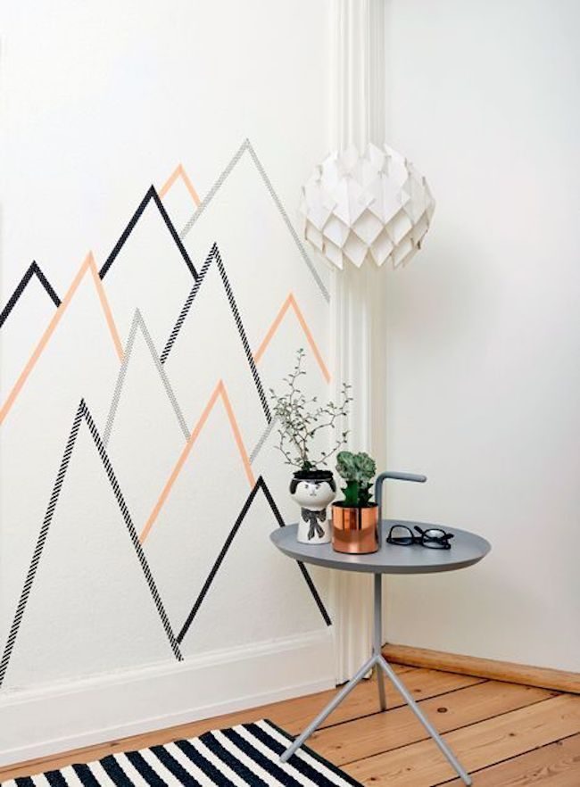 Mountains in masking tape on this white wall 