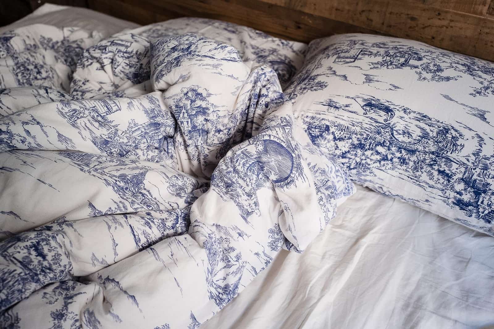 Choosing the Perfect Sheets: Should You Choose Bamboo Sheets? Beautifully Comfortable White Linen with Blue Patterns